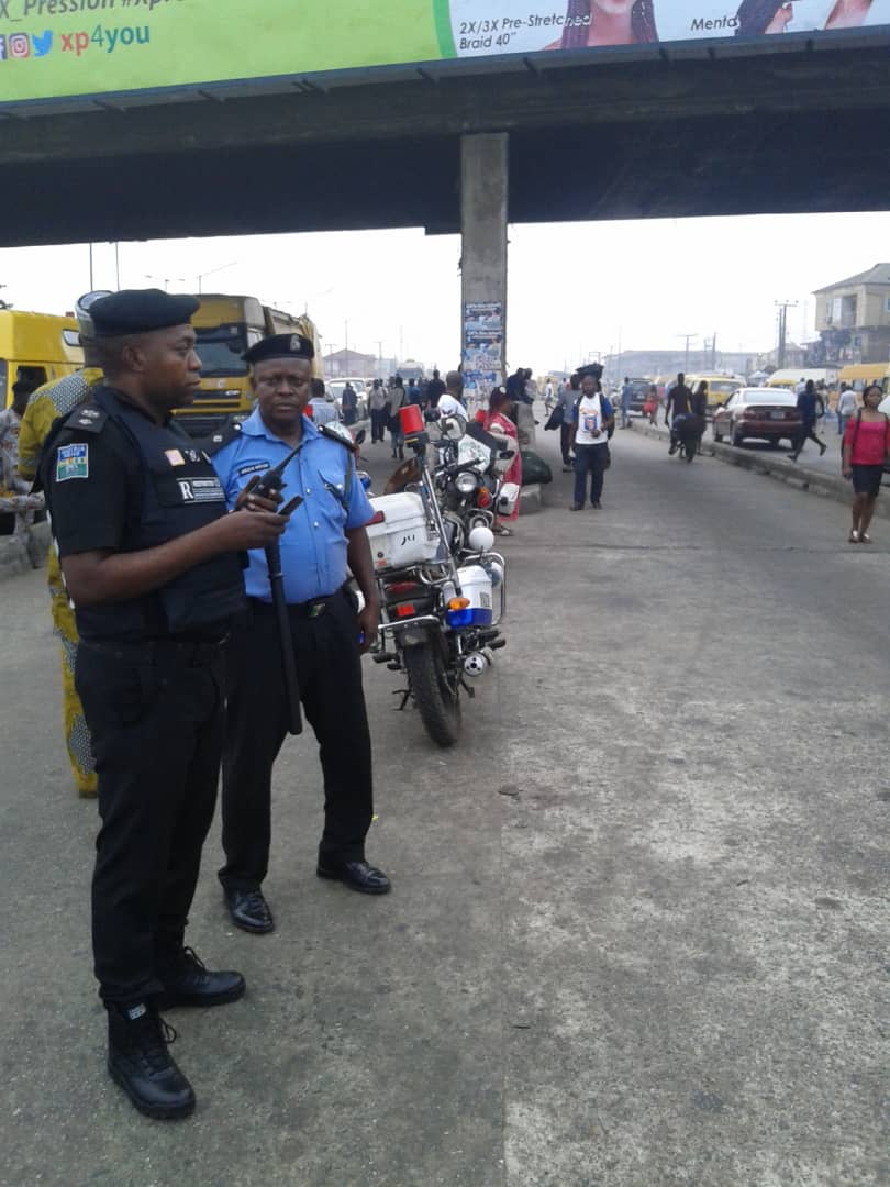 Police from Iyana-Ipaja division at the bus stop parading to access level of compliance as well as arrest defaulters