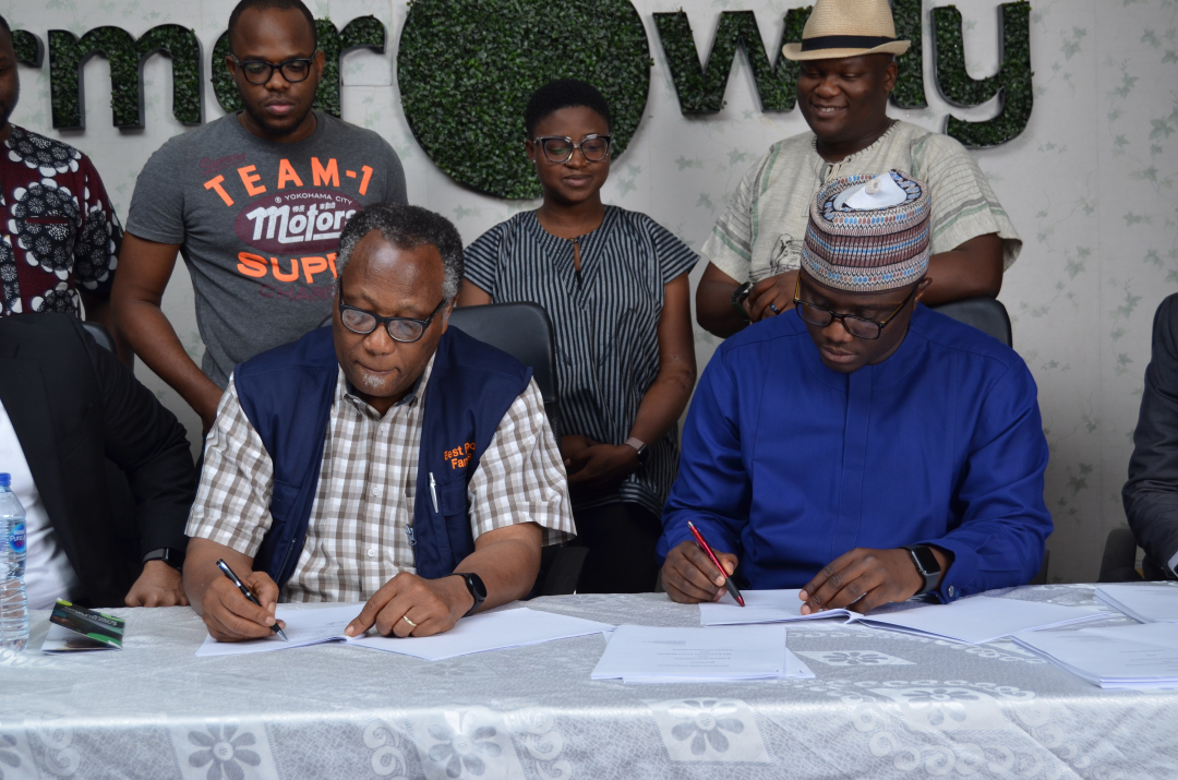 The Chairman, Best Foods L&P Limited, Mr. Emmanuel Ijewere and Founder and CEO of Farmcrowdy, Onyeka Akumah signing the acquisition deal at the Farmcrowdy office in Lagos, Nigeria
