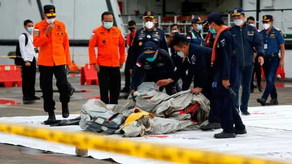 Military Recover Body Parts From Indonesian Plane Crash Site