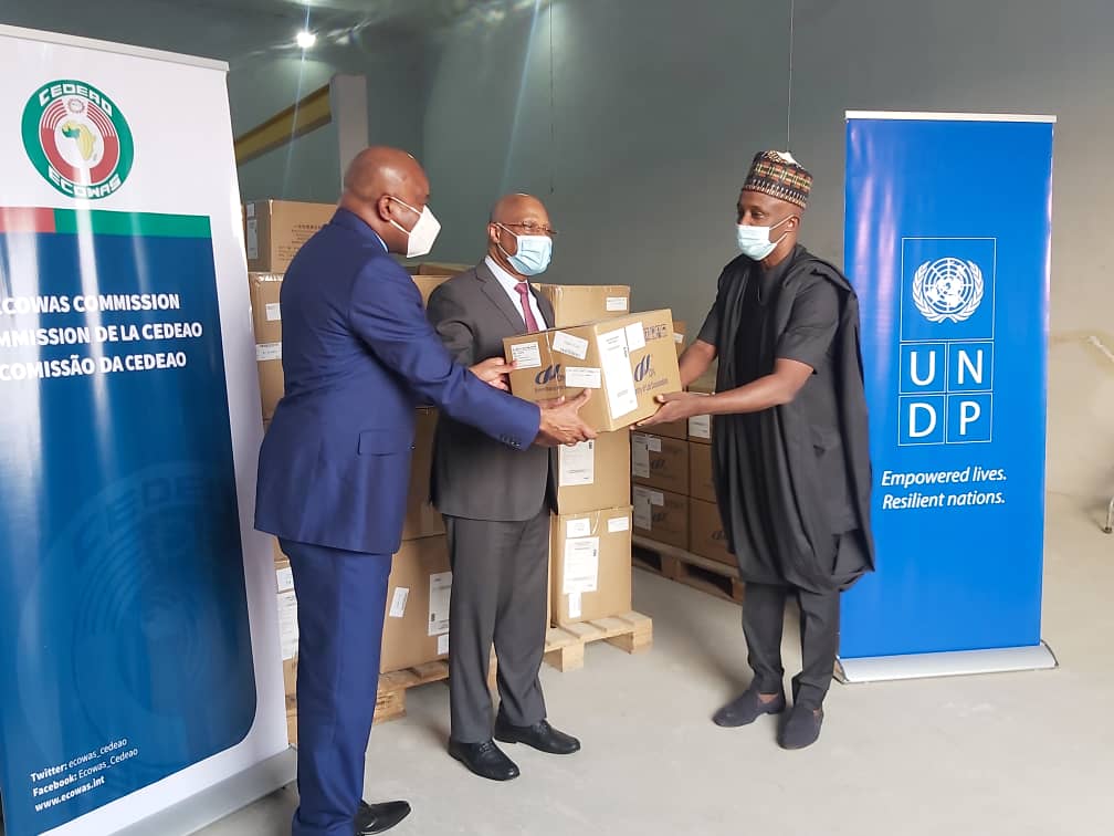 From L-R: Prof. Stanley Okolo, Dg West African Health Organisation (WAHO), President of ECOWAS Jean-Claude Brou and Country Representative of UNDP Mohamed Yahya during the handover of 14 million dollars worth of COVID-19 kits in Abuja on Wednesday