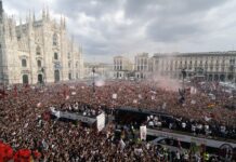AC Milan supporters cheer their team as