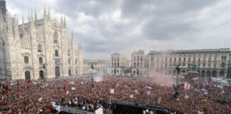 AC Milan supporters cheer their team as