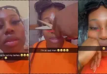 Nigerian Lady In Pain As Immigration Officer Trims Her Eyelashes During Passport Renewal